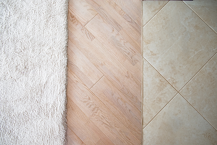three different types of flooring - Laminate parquete floor. Light wooden texture. Beige soft carpet. - Branson, MO