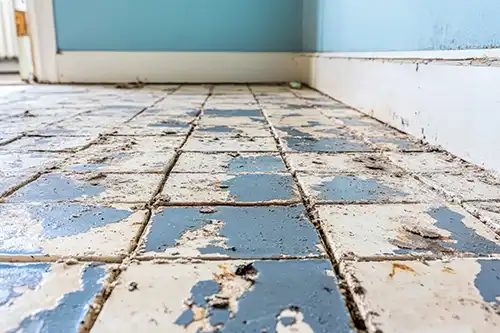 Sho-Me Flooring—Aging tile floor with scratches and damages in a home in Branson, MO.